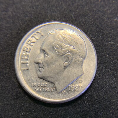 1987 Roosevelt dime off-center strike error showing blank crescent and shifted design
