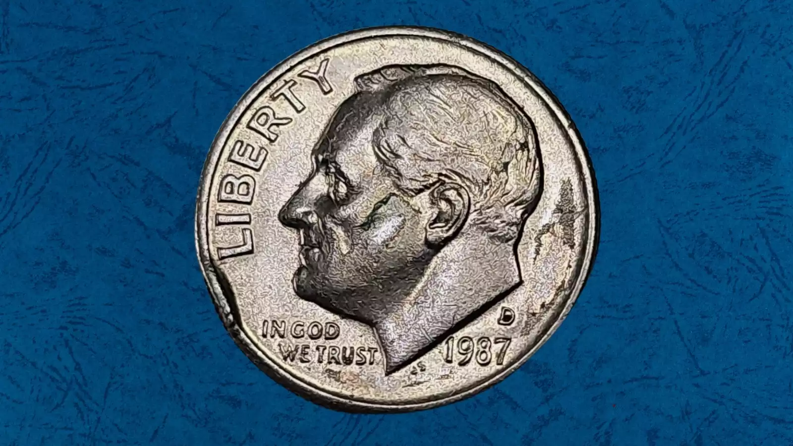 1987 Roosevelt dime die crack and cud error showing raised metal line across the coin surface